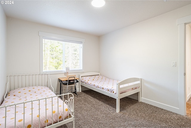 bedroom featuring baseboards and carpet floors