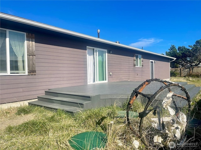 rear view of property with a wooden deck