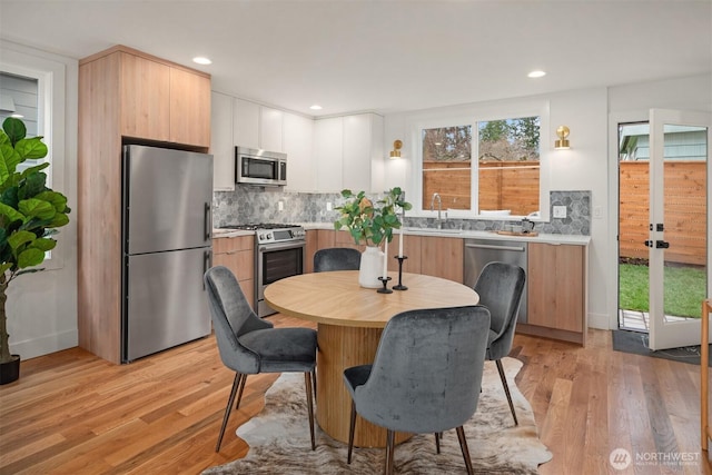 dining space with recessed lighting and light wood-type flooring