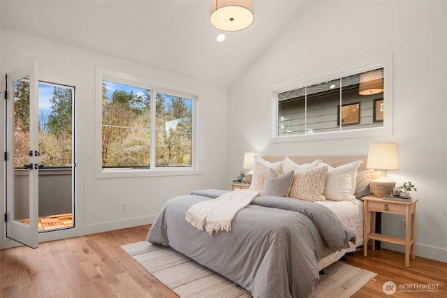 bedroom with lofted ceiling, recessed lighting, wood finished floors, and baseboards