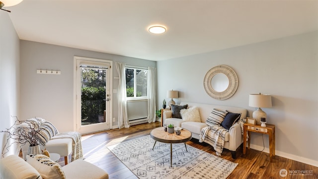 living area with baseboards, baseboard heating, and wood finished floors