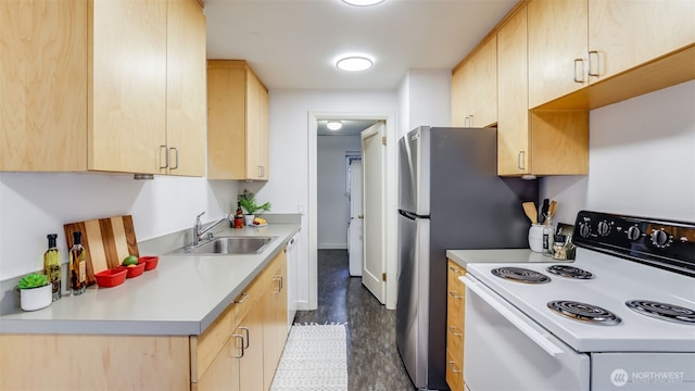 kitchen featuring light countertops, electric stove, light brown cabinets, and a sink