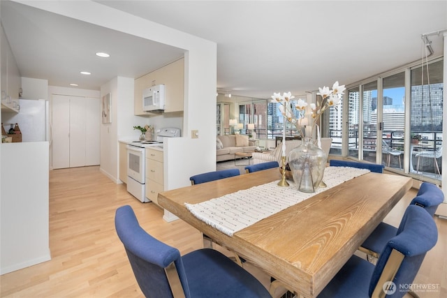 dining space featuring recessed lighting and light wood-style floors