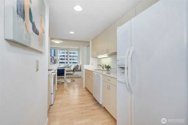 kitchen with recessed lighting, white appliances, light wood-type flooring, and light countertops