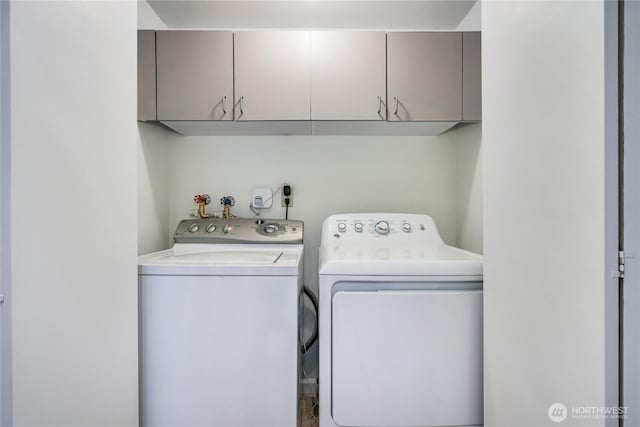 laundry room with cabinet space and washing machine and clothes dryer