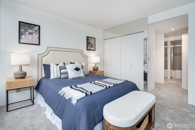 carpeted bedroom featuring a closet and connected bathroom