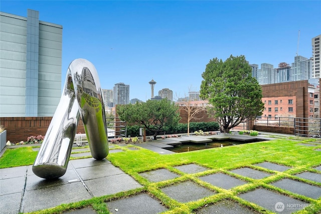 view of home's community featuring a city view and fence