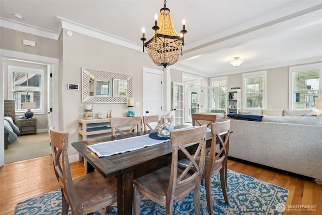 221 Meriweather St, Pacific Beach, WA 98571 - dining space featuring wood finished floors, baseboards, french doors, crown molding, and a notable chandelier
