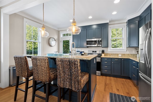 221 Meriweather St, Pacific Beach, WA 98571 - kitchen featuring light wood finished floors, crown molding, light stone countertops, a breakfast bar, and stainless steel appliances