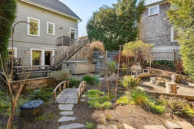 221 Meriweather St, Pacific Beach, WA 98571 - exterior space with fence, an outdoor fire pit, stairway, a wooden deck, and a hot tub