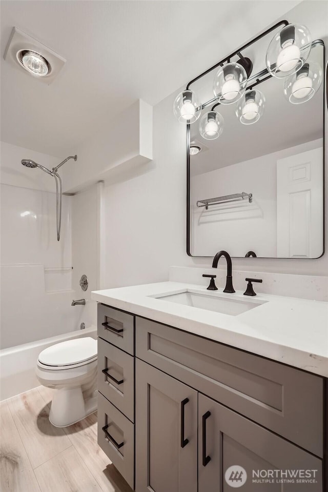 full bathroom featuring toilet, bathtub / shower combination, and vanity