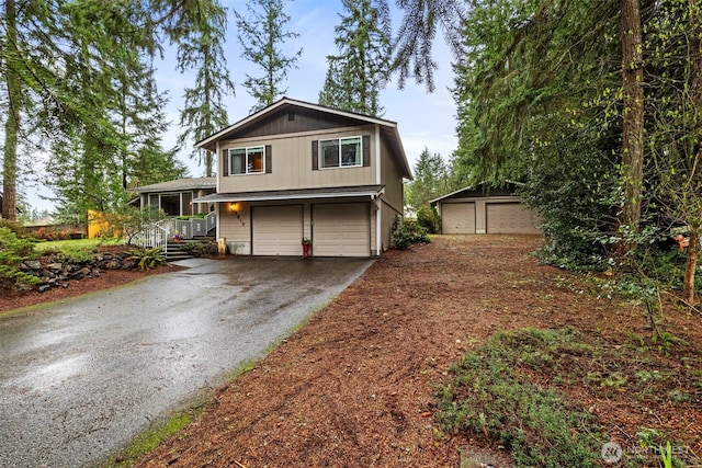 view of front of house with a garage and aphalt driveway