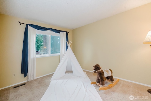 playroom featuring carpet flooring, baseboards, and visible vents