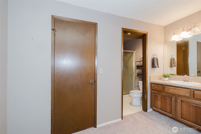 full bathroom featuring a shower with door, toilet, a textured ceiling, and vanity