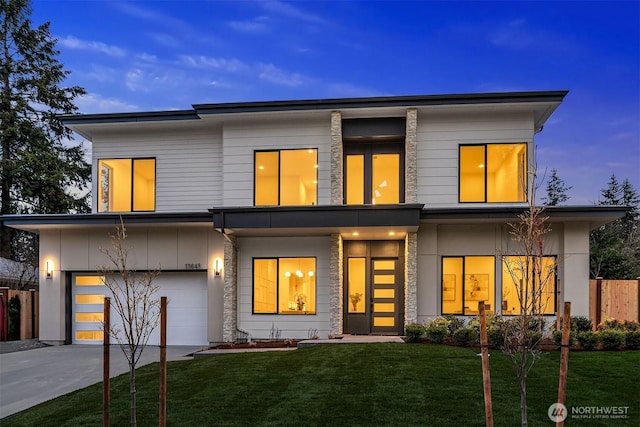 view of front of house with a garage, driveway, and a front lawn