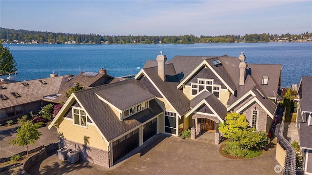 birds eye view of property with a water view