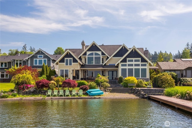 back of house featuring a chimney and a water view