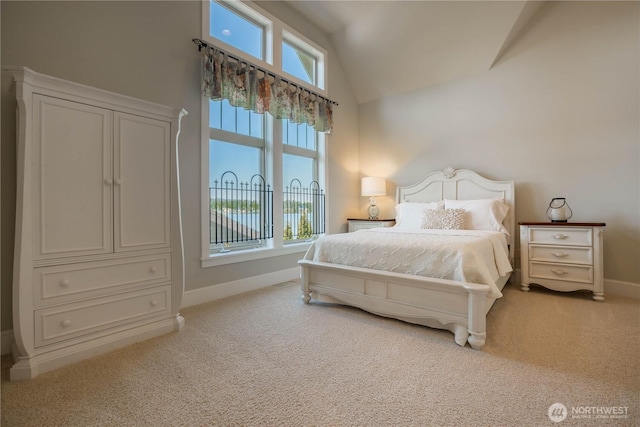 bedroom with vaulted ceiling, carpet, and baseboards