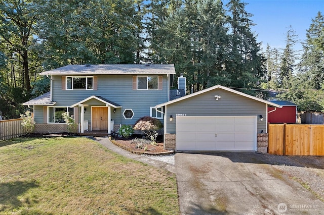 traditional-style home with aphalt driveway, an attached garage, a front lawn, and fence