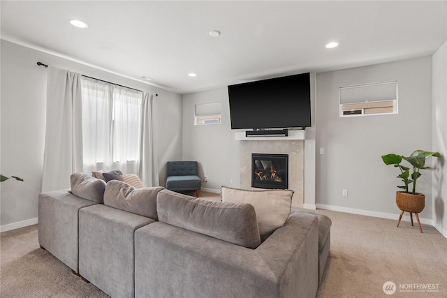 living room featuring light carpet, recessed lighting, baseboards, and a tile fireplace