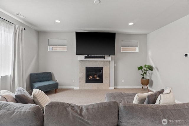 carpeted living room with visible vents, recessed lighting, a tile fireplace, and baseboards