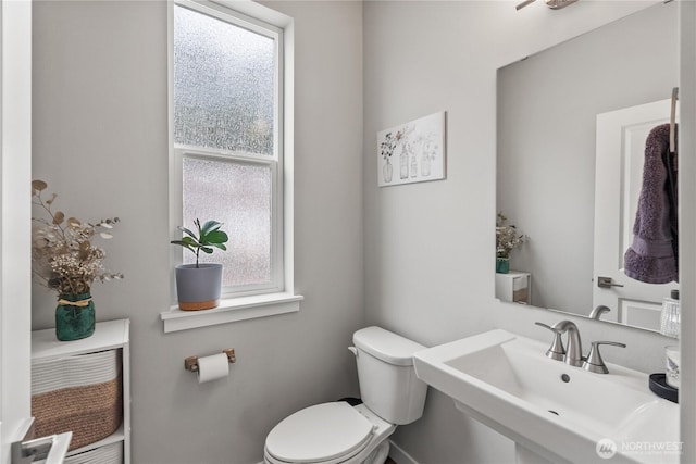 half bath featuring a sink and toilet