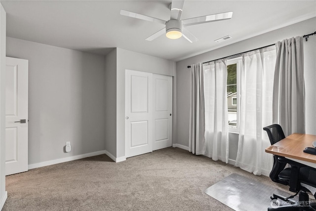 carpeted office space with visible vents, baseboards, and ceiling fan