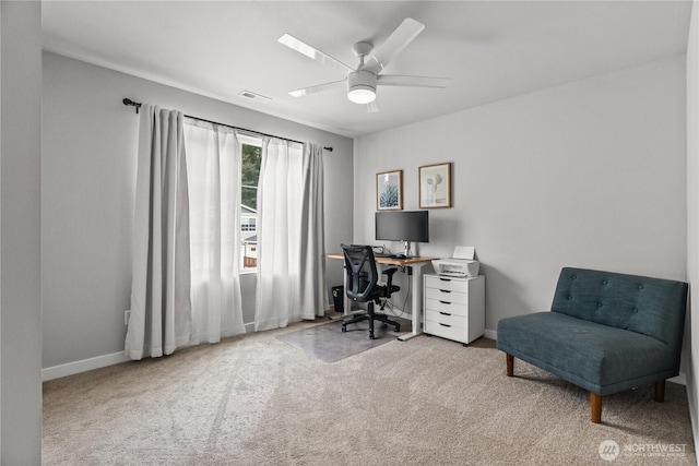 carpeted office space featuring visible vents, baseboards, and ceiling fan