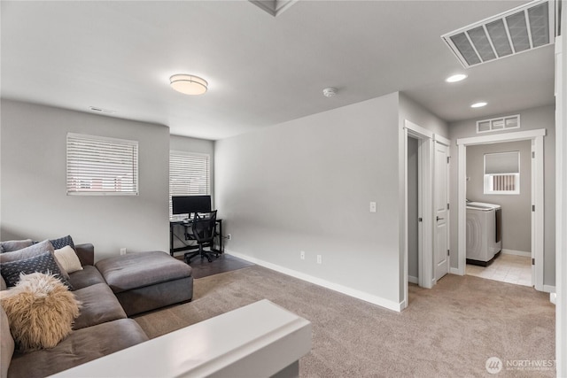 living area with visible vents, baseboards, and light colored carpet