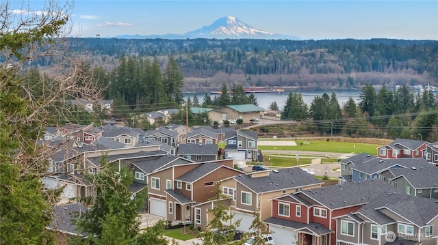 bird's eye view with a residential view, a wooded view, and a water view