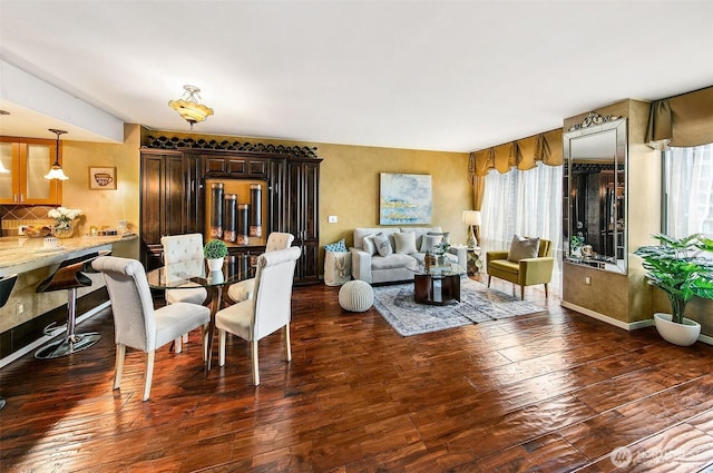 dining space with hardwood / wood-style flooring and baseboards