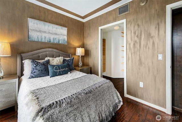 bedroom featuring visible vents, baseboards, and wood-type flooring