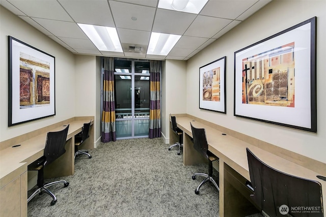 office area featuring carpet flooring, visible vents, a drop ceiling, and built in study area