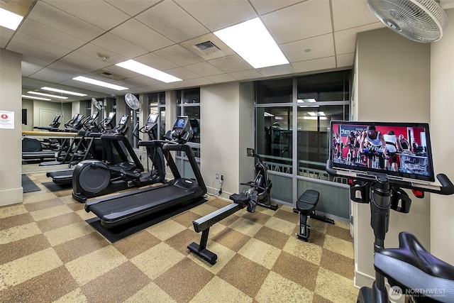 workout area featuring a drop ceiling, baseboards, and visible vents