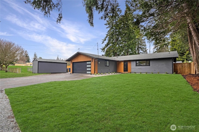 view of front of property with a garage, concrete driveway, a front lawn, and fence