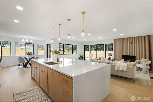 kitchen featuring a sink, light wood-type flooring, recessed lighting, and light countertops