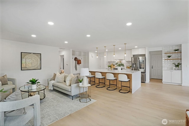 living room with recessed lighting and light wood-style floors