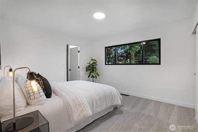 bedroom with visible vents, baseboards, and carpet