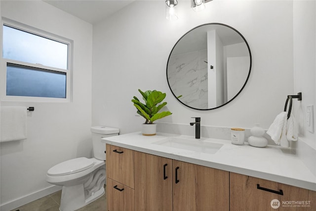 bathroom with tile patterned flooring, toilet, and vanity