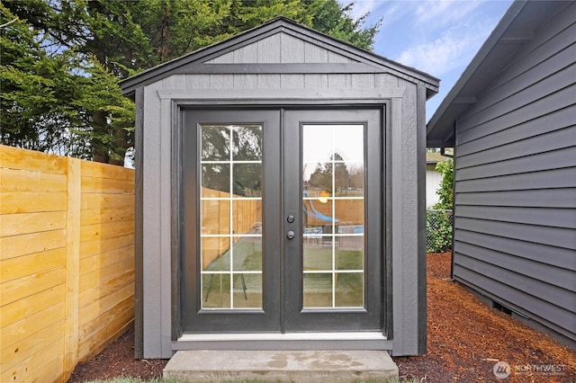 view of outdoor structure with an outbuilding and fence