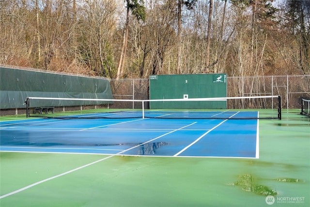 view of sport court featuring fence