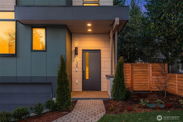 view of exterior entry featuring fence