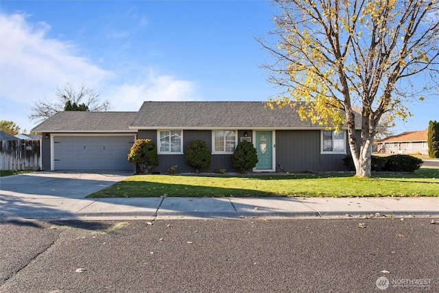 ranch-style house featuring a garage, driveway, and a front yard