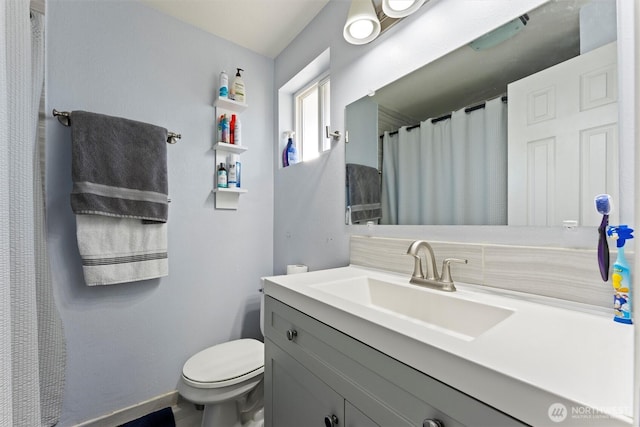 full bath featuring baseboards, toilet, and vanity