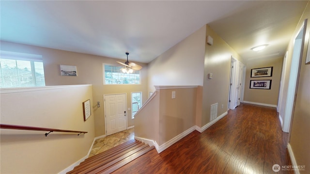 interior space featuring plenty of natural light, wood finished floors, visible vents, and baseboards