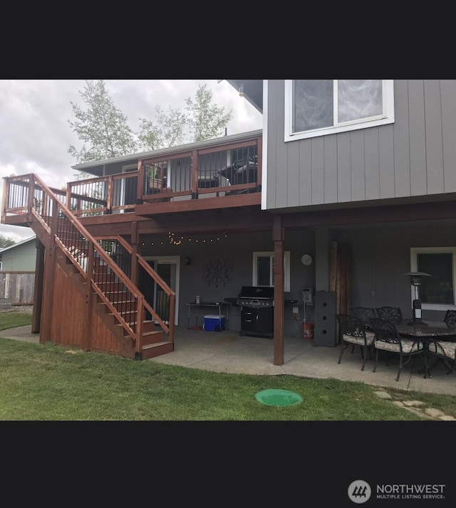 rear view of house with stairs, a yard, and a patio area