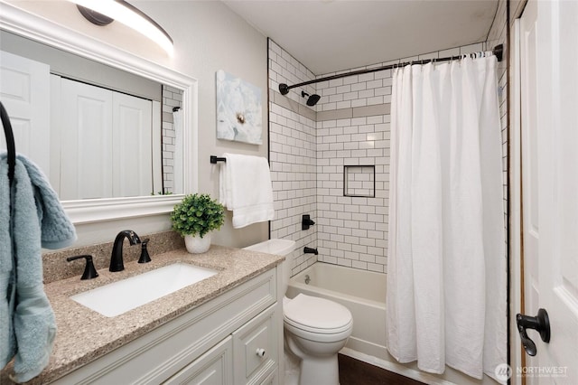 bathroom with toilet, vanity, and shower / bathtub combination with curtain