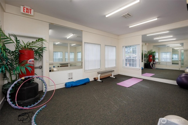 workout area featuring carpet, visible vents, and baseboards