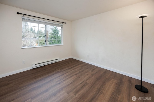 spare room featuring baseboards, baseboard heating, and wood finished floors