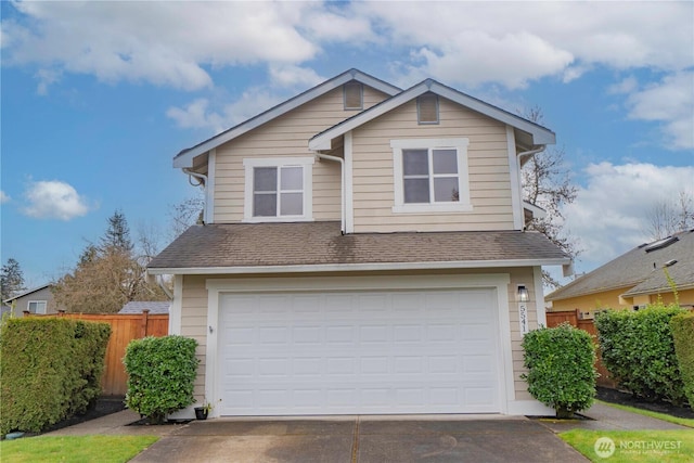 view of front of home featuring a garage, driveway, roof with shingles, and fence